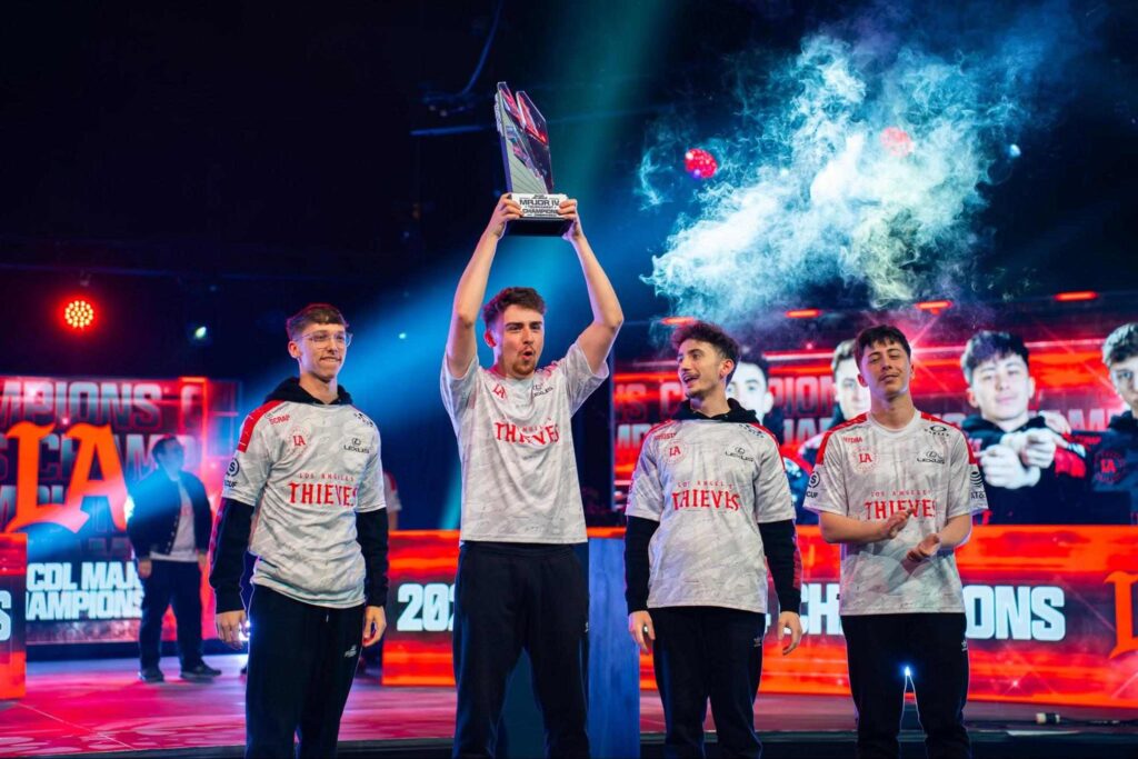 Los Angeles Thieves players celebrating on stage after a Call of Duty League victory, holding the championship trophy, representing one of the twelve franchise teams competing at CDL 2026 Major 3.